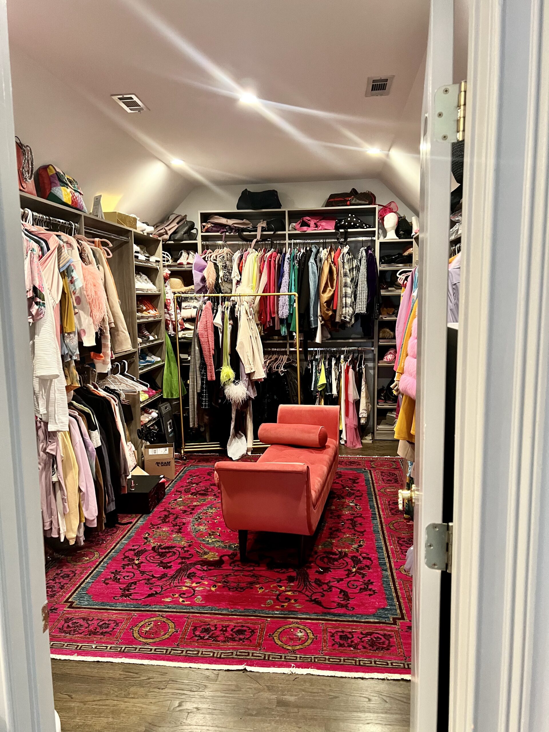 Luxury walk-in closet cluttered with designer bags and scattered clothing before Imagine Organizing's service — Closet Organizing in Chamblee