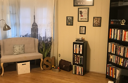 Organized home office nook with a New York City skyline curtain, bookshelf, and framed certificates by Imagine Organizing — Interior Design in Avondale Estates