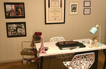 Organized home office desk with a task lamp, cart, and framed diplomas by Imagine Organizing — Interior Design in Avondale Estates