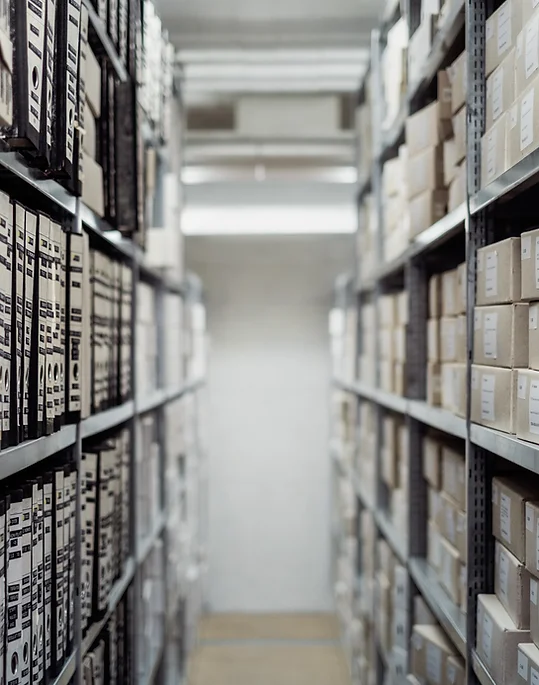 Blurred rows of archive boxes on industrial warehouse shelving — Business Organizing in Hapeville