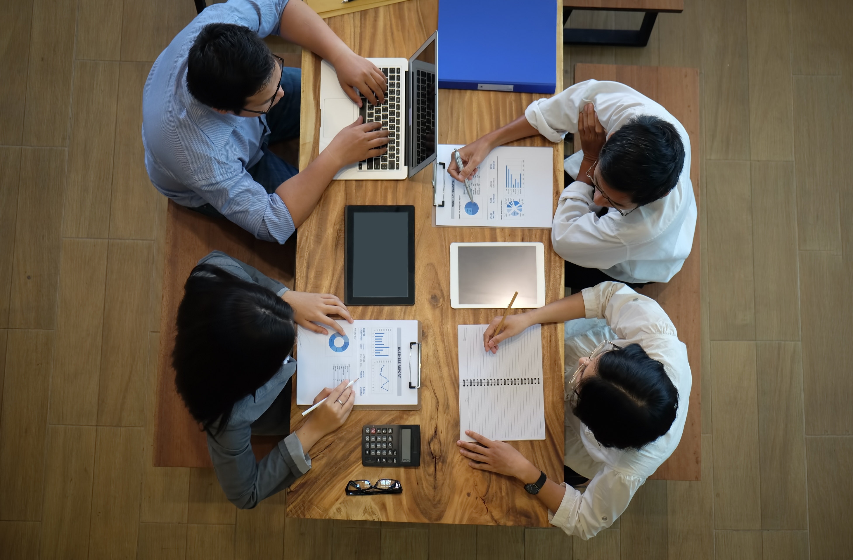 Overhead view of a business team collaborating around a table with laptops and reports — Business Organizing in Union City