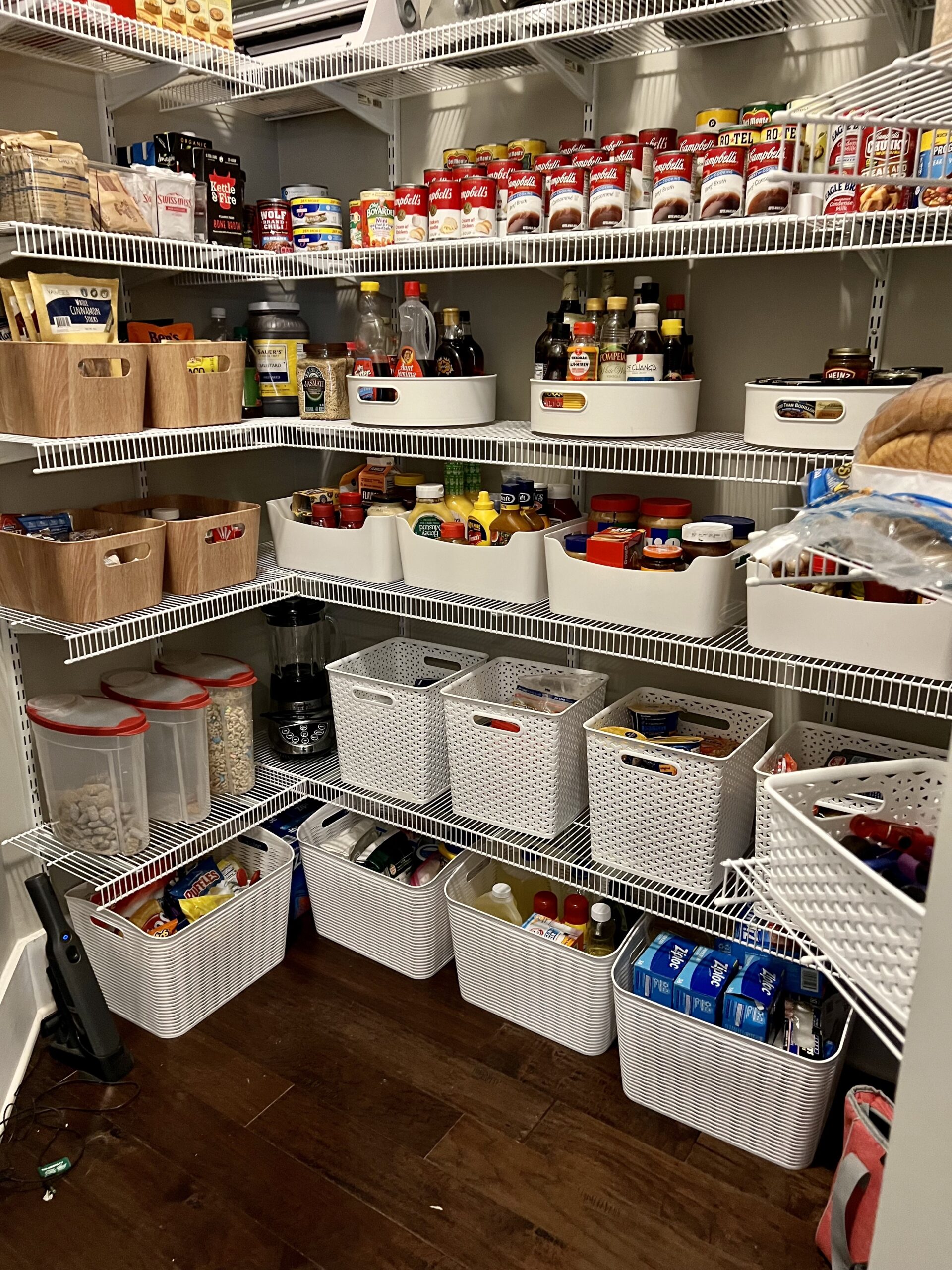 Organized pantry shelving with canned soups, cereal canisters, and snacks grouped by category by Imagine Organizing — Home Organizing in Avondale Estates