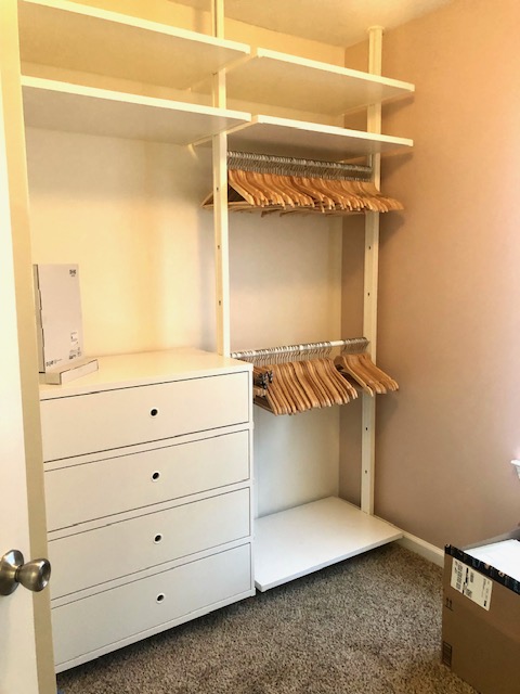 Custom closet shelving and hanging rods installed before styling by Imagine Organizing — Closet Organizing in Decatur