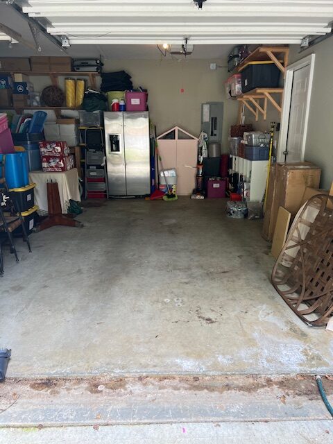 Garage with holiday storage bins on overhead shelving and a refrigerator, organized by Imagine Organizing — Moving Services in Marietta