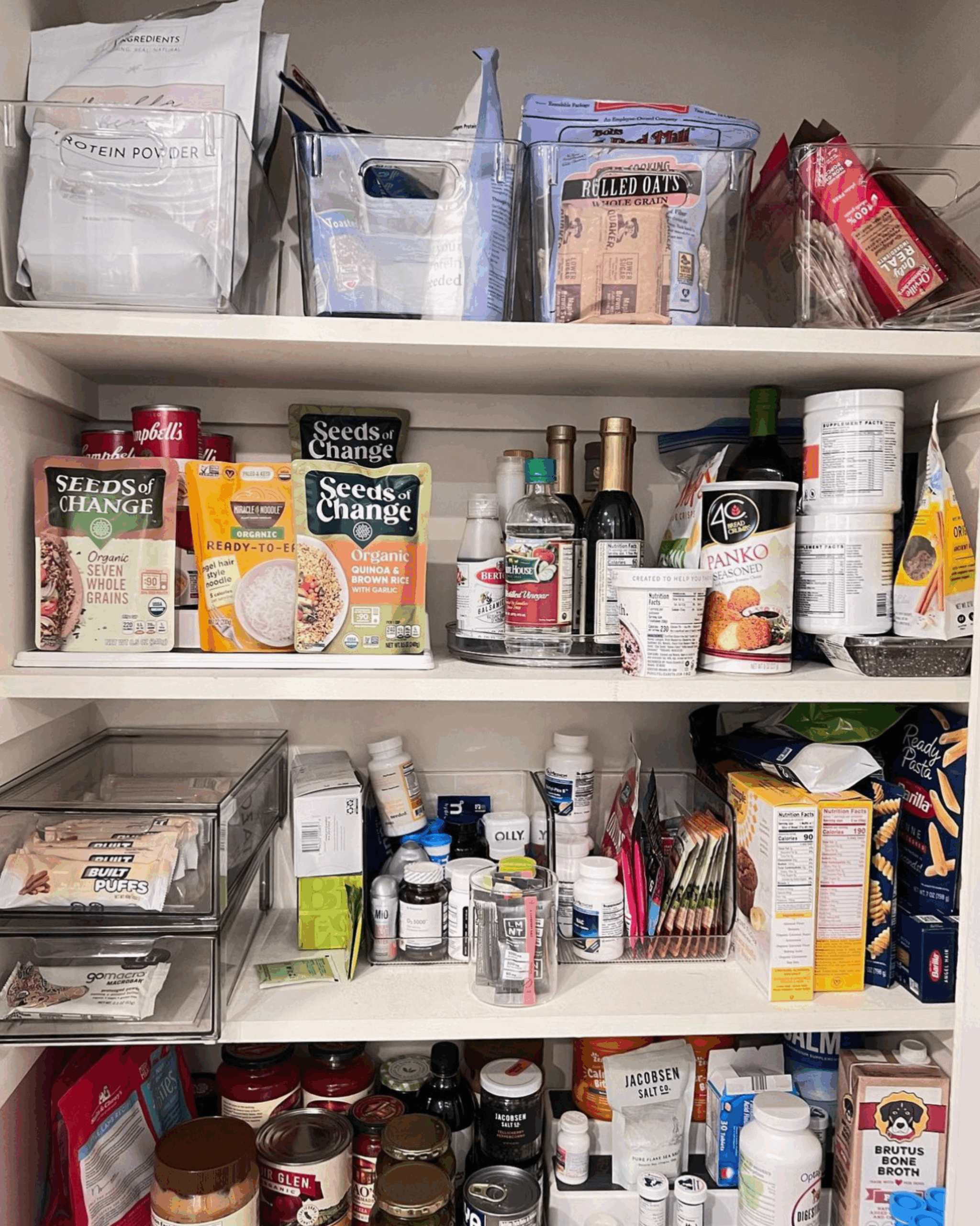 Organized pantry with labeled clear bins for pantry staples and snacks by Imagine Organizing