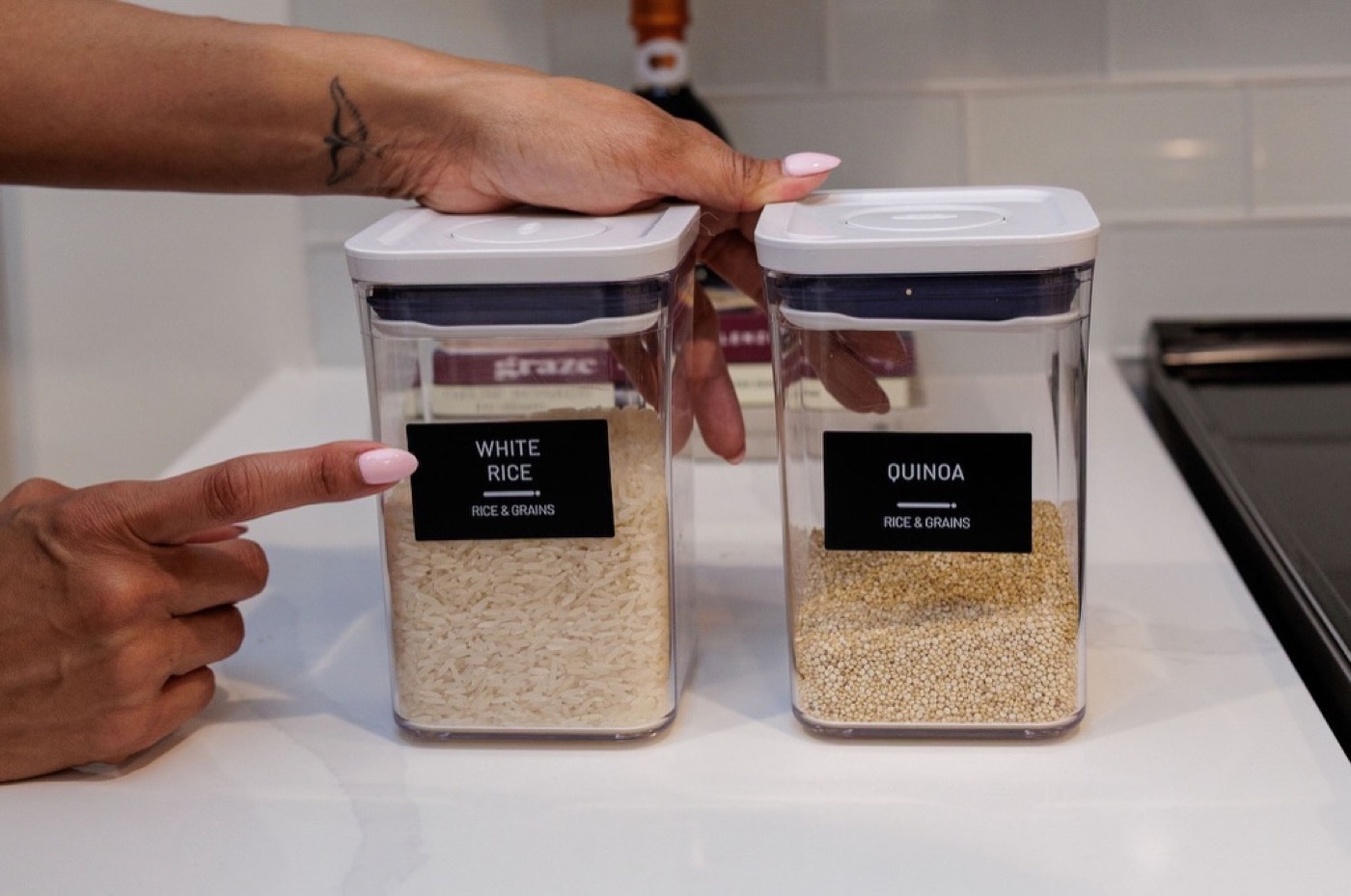 Clear airtight pantry containers labeled white rice and quinoa on a kitchen counter — Interior Design in Riverdale