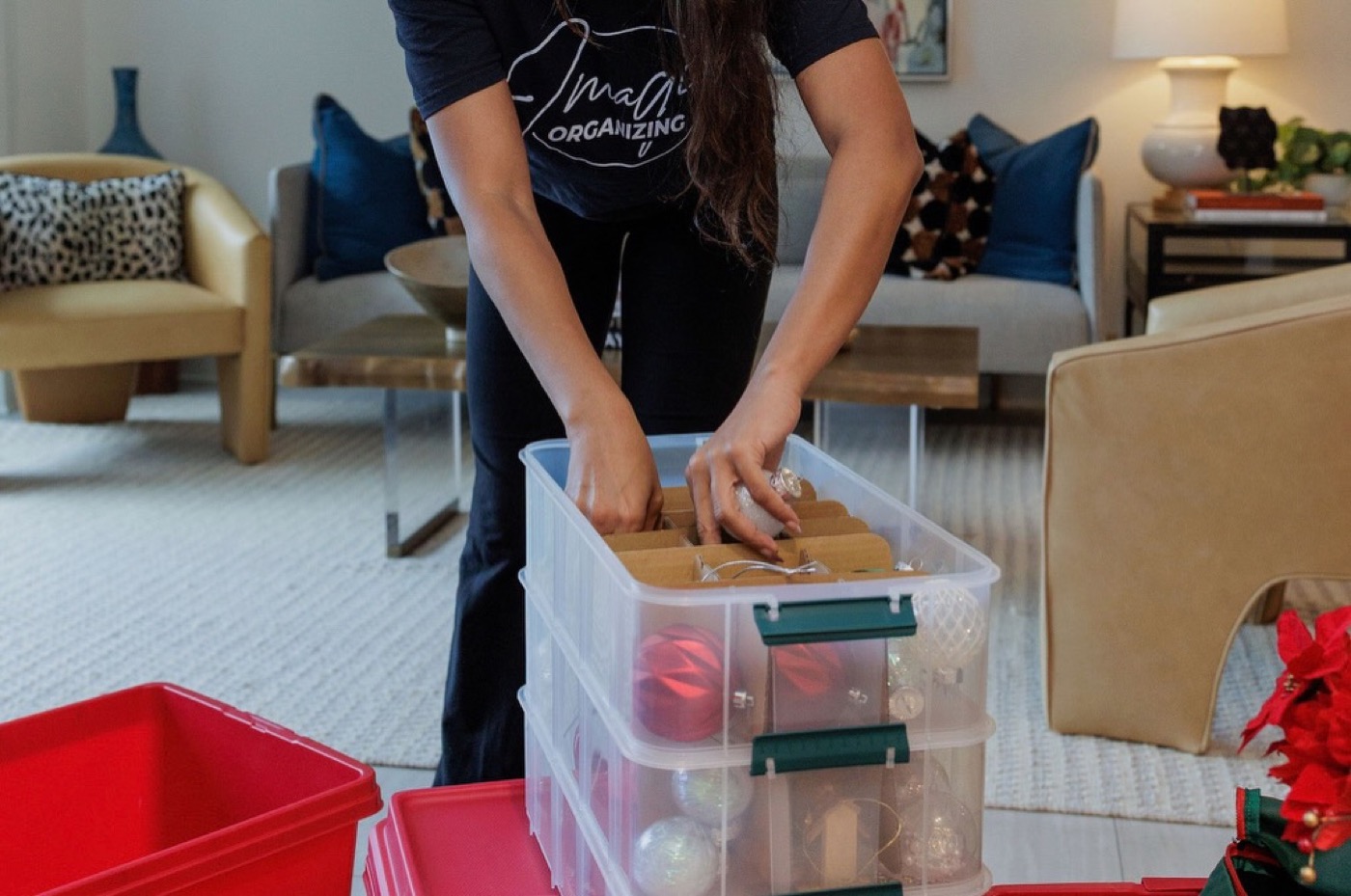 Imagine Organizing team member packing glass holiday ornaments into a stackable clear bin — Concierge Services in Brookhaven
